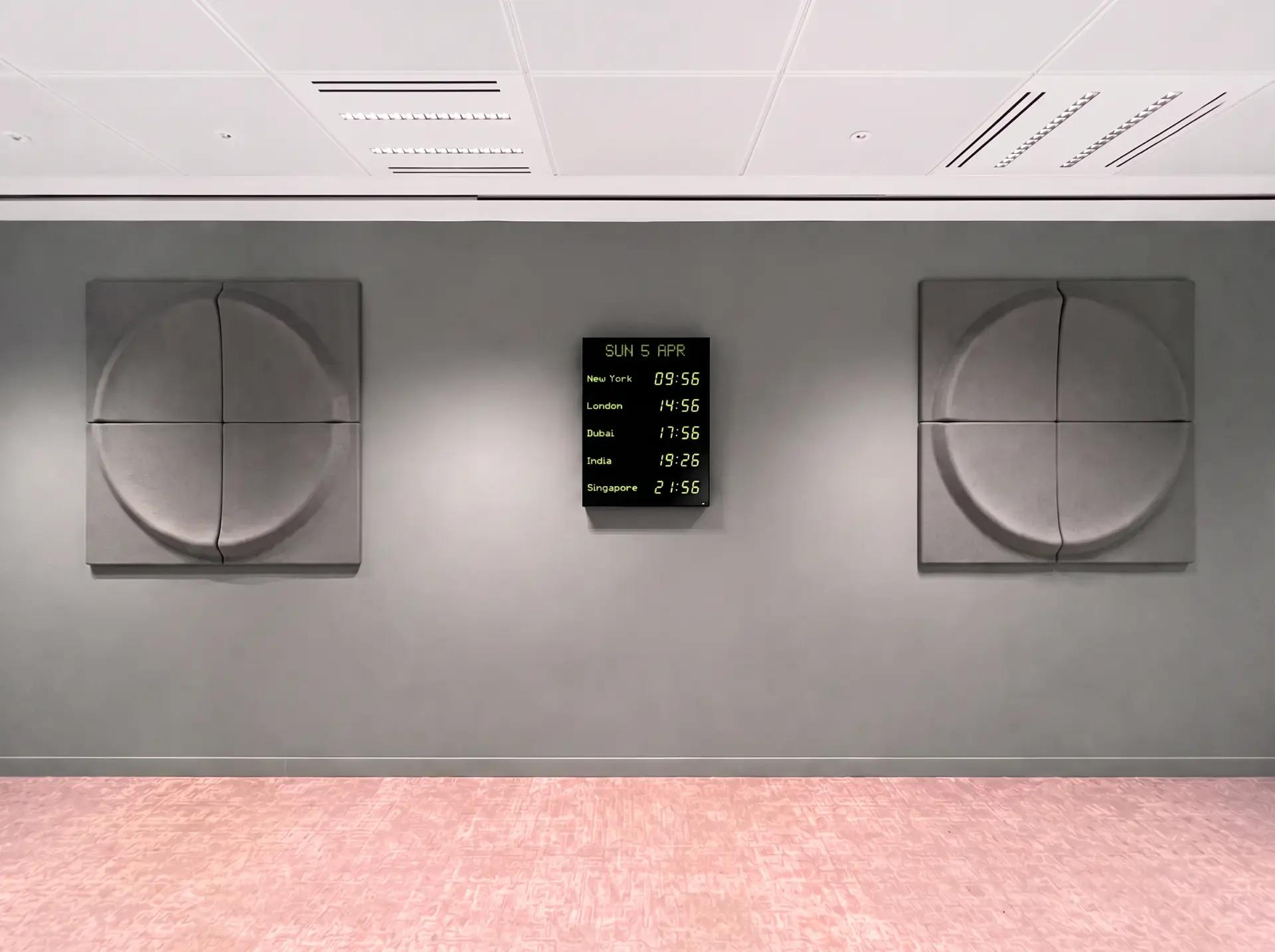 Five-zone vertical display with calendar in green on acoustic-panel wall